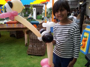 Happy Kid with Ostrich Balloon at Party