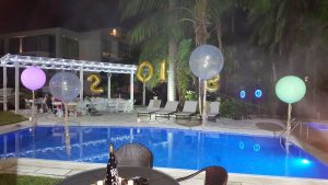 New Years Eve giant lit up plain and confetti filled balloons with balloon numbers arch