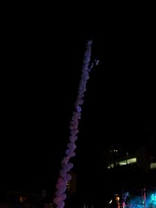Balloon garland into the sky at night with lights