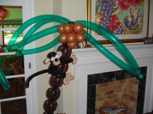 Balloon monkey on palm tree with framework