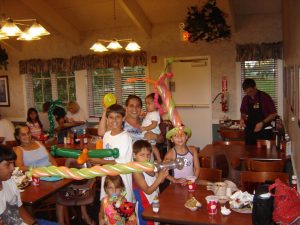 Happy faces with balloons at a restaurant