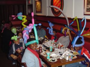 Happy kids with balloons at a restaurant