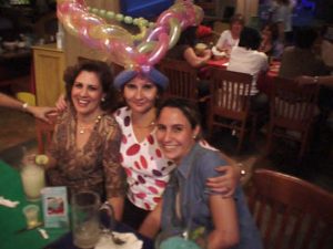 Ladies enjoying Chevy's Fresh Mex with a balloon hat