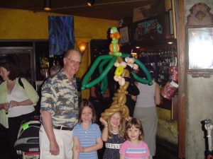 Monkey on a tree balloon hat with a parrot