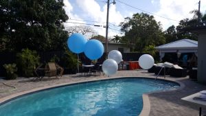 Three foot balloons in a pool